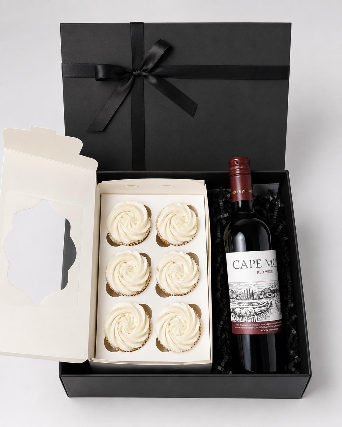 Six decorated cupcakes with a bottle of non-alcoholic red wine in a Trelluna gift set