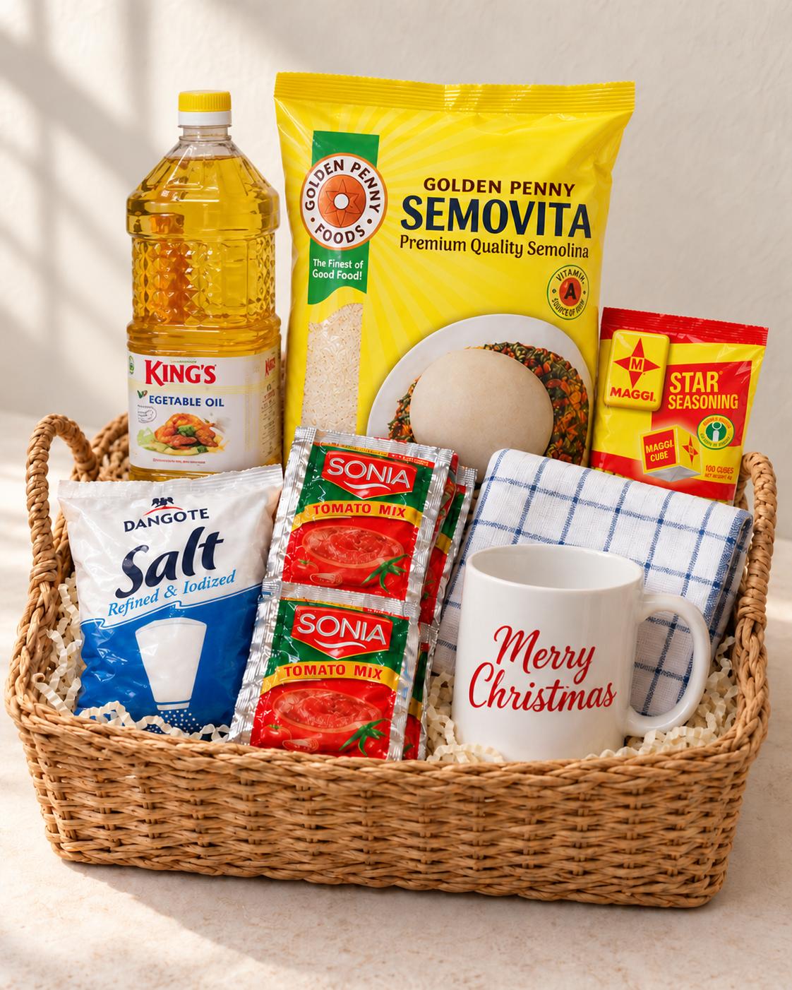 Festive Christmas pantry basket with groundnut oil, Sonia tomato, Semovita, Maggi, salt, napkin and customized mug