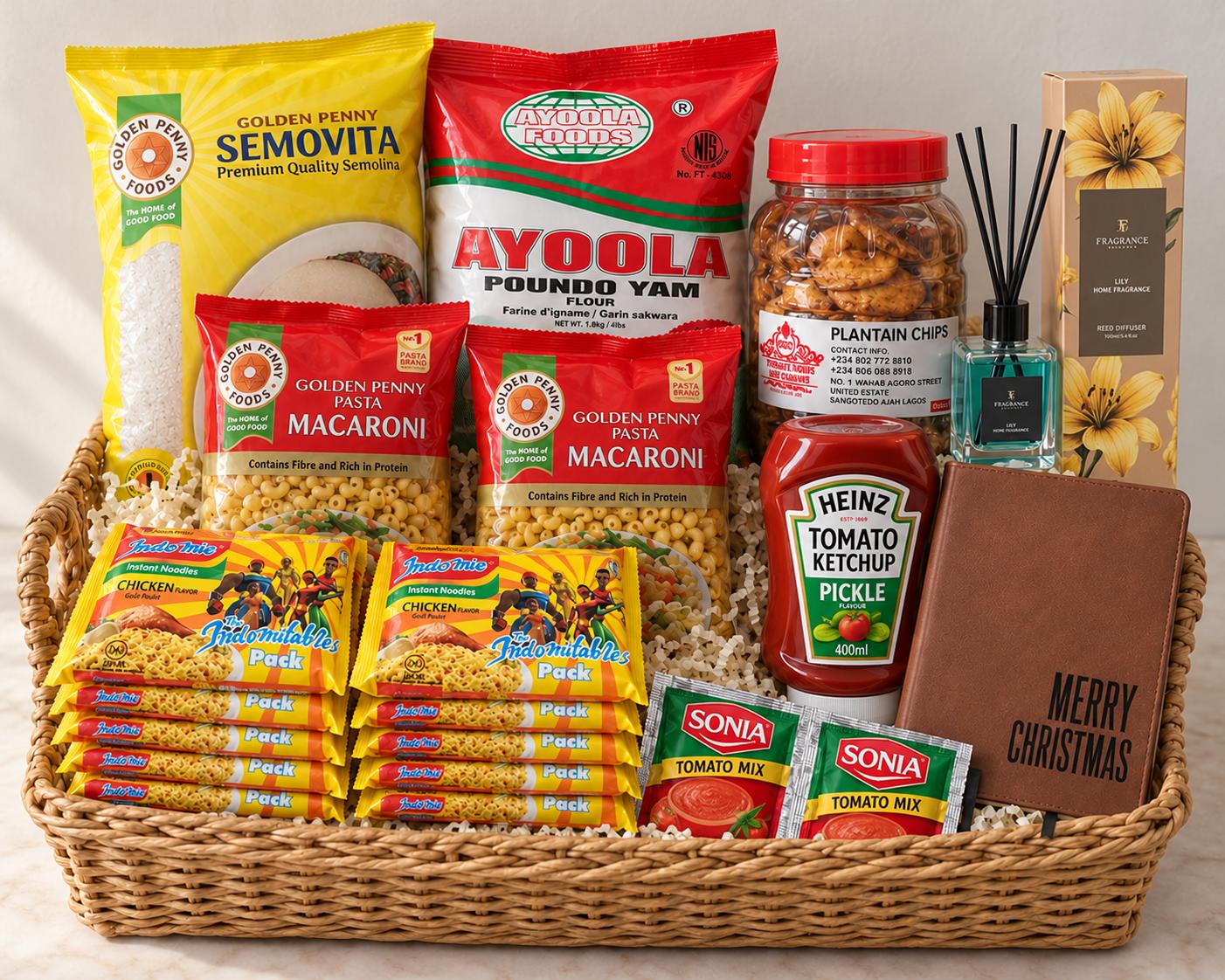 Christmas hamper basket with Semovita, Poundo, tomato paste, noodles, macaroni, plantain chips, diffuser, ketchup and customized journal